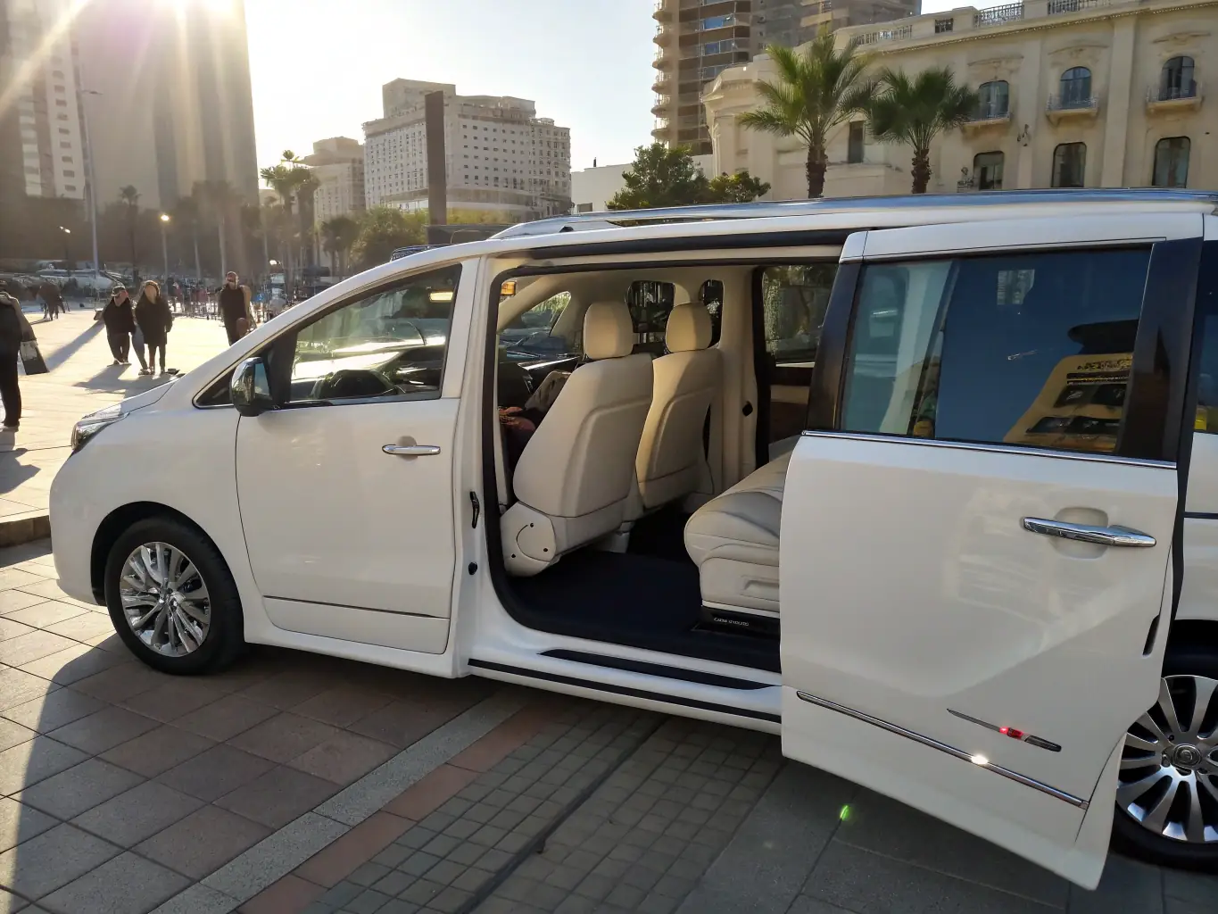 A modern, well-maintained minibus parked in front of a corporate building, ready to transport personnel. The scene is set during a sunny day, emphasizing reliability and comfort.